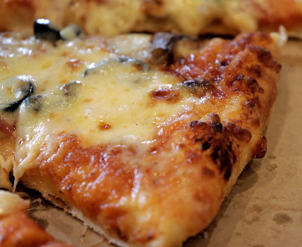 The cheese gives the pizza crust an extra crunch.